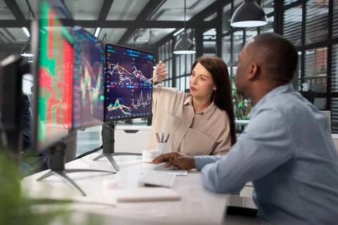 Team Of Stock Traders Use Multiple Monitors For Secure Exchange Stock Photos