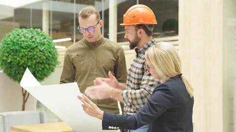 Team of structural engineering designers are working on the blueprints and Stock Footage 146542435