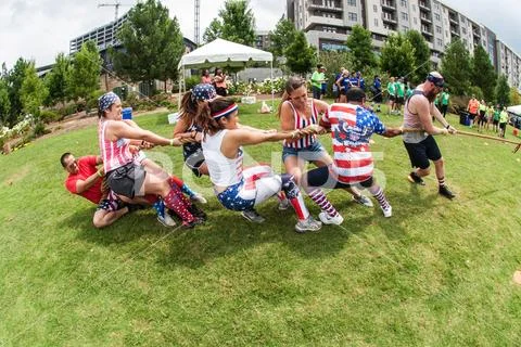 Team Struggles To Pull Rope In Tug Of War Contest Stock Photos