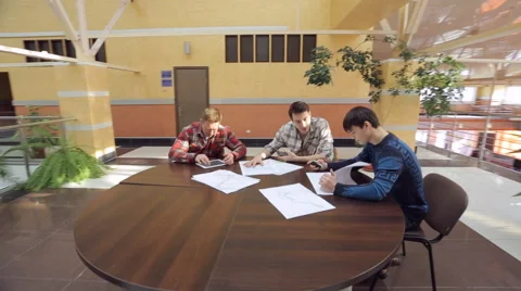 Team of students develop project at round table, discuss idea, solve problem Video stock 64191886