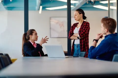 A team of successful programmers sits in a startup office, strategizing new Fotos Stock