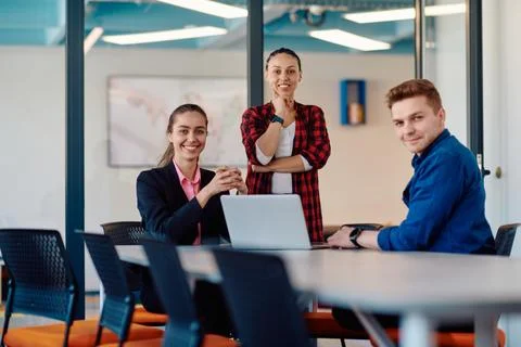 A team of successful programmers sits in a startup office, strategizing new Fotos Stock