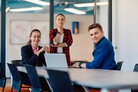 A team of successful programmers sits in a startup office, strategizing ne... Stock-Fotos