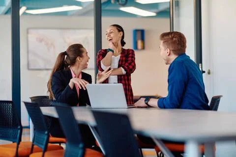 A team of successful programmers sits in a startup office, strategizing ne... Stock-Fotos