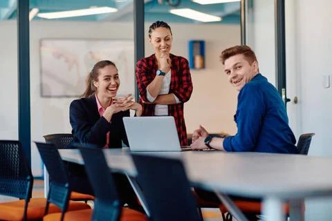 A team of successful programmers sits in a startup office, strategizing ne... Stock-Fotos