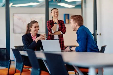 A team of successful programmers sits in a startup office, strategizing ne... Stock-Fotos