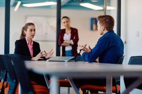 A team of successful programmers sits in a startup office, strategizing ne... Stock-Fotos