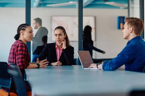 A team of successful programmers sits in a startup office, strategizing ne... Stock-Fotos