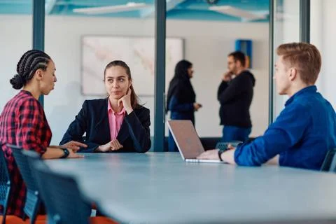 A team of successful programmers sits in a startup office, strategizing ne... Stock-Fotos