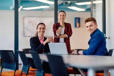 A team of successful programmers sits in a startup office, strategizing ne... Stock-Fotos