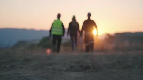 Team of sucessful engineers check new construction location at sunset, sunris Stock Footage 246586911