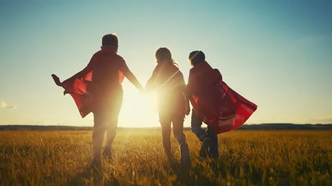 Team superhero. a group of children are running across the field in a superhero Stock Footage 213530341