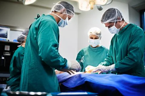 Team, surgeon and surgery in operating room for healthcare procedure, treatment Stock Photos