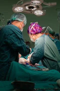 Team surgeon at work in operating room. Stock Photos