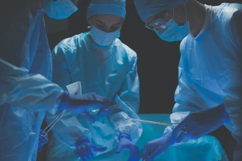 Team surgeon at work in operating room. Stock Photos