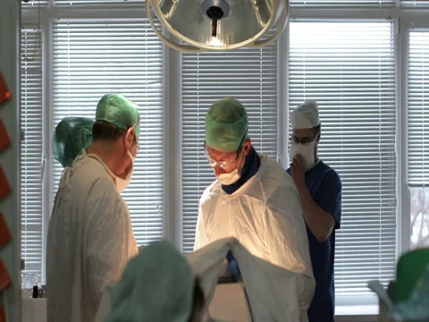 A team of surgeons are in the operating room. Stock Footage 73893950