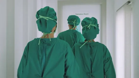 Team of surgeons are rushing into the operating room to perform timely Stock Footage 189379099