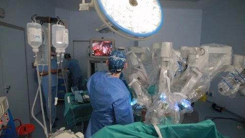 Team of surgeons doctors in operations room using robotic arms for surgery ro 動画素材 102223882