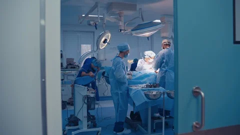 Team of surgeons doing plastic surgery in modern clinic. Video stock 127709327
