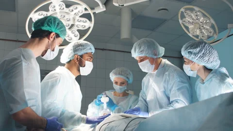 Team of Surgeons Operating in the Hospital Stock Footage 99784252