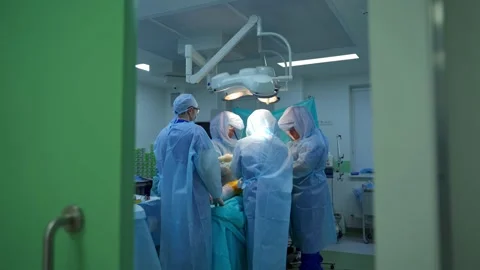 Team of surgeons in operating room. Video stock 135399613