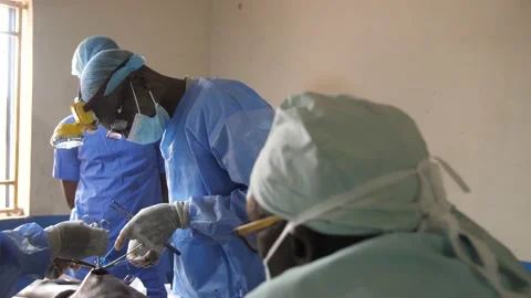 Team of surgeons in operating theater performing operation on a patient . Stock Footage 155716820