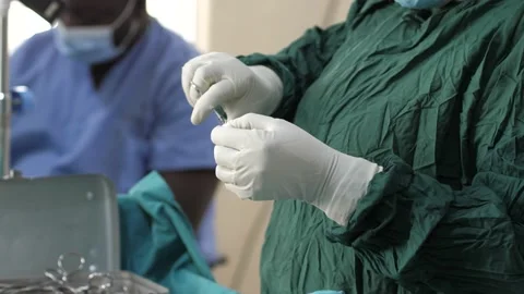 Team of surgeons in operating theater performing operation on a patient . 動画素材 156015672