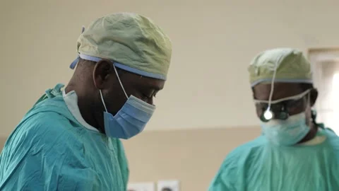 Team of surgeons in operating theater performing operation on a patient . 動画素材 156016601