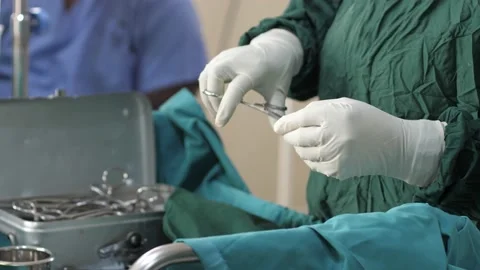 Team of surgeons in operating theater performing operation on a patient . Stock Footage 156116021