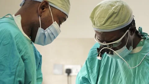 Team of surgeons in operating theater performing operation on a patient . Stock Footage 156116295