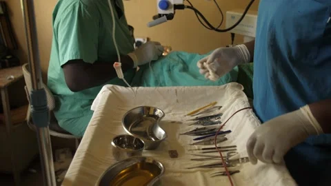Team of surgeons in operating theater performing operation on a patient . Stock Footage 165429972