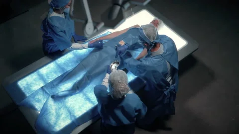 Team of surgeons perform a delicate operation using futuristic medical bed Stock Footage 157174804