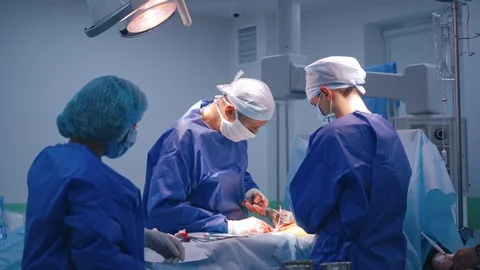 Team of surgeons perform an operation. Professional doctor Stock Footage 125895048