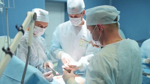 A team of surgeons performed a successful operation, stitches and stitches .. Stock Footage 253313201