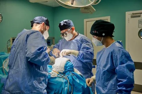 Team of surgeons performing operation Stock Photos