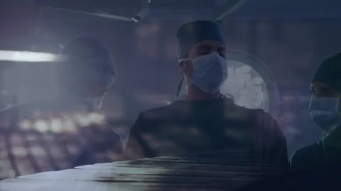 Team of surgeons performing surgery at hospital against time-lapse of people Stock Footage