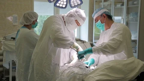 The team of surgeons is performing surgical intervention using innovative Stock Footage 94019313