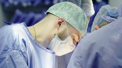 A team of surgeons at work in the operating room. Stockbeeldmateriaal 269481345