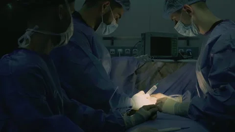 A team of surgeons at work in the operating room. Stock Footage 270460691