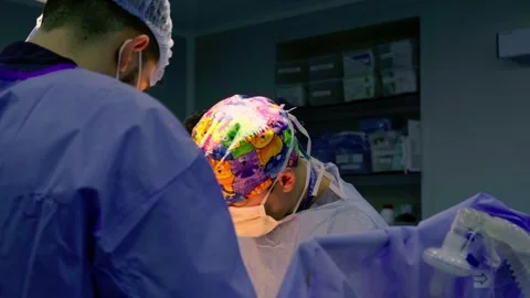A team of surgeons at work in the operating room. Stock Footage 270466236