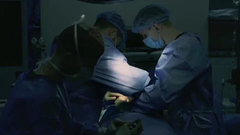 A team of surgeons at work in the operating room. Stock Footage 270466797