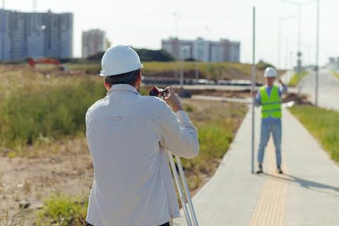 Team survey construction engineer use level survey camera. Stock Photos