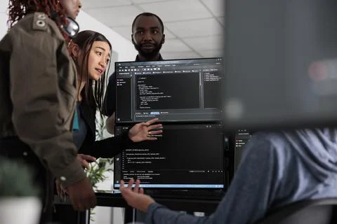 Team of system engineer writing data and discussing about coding language Stock Photos