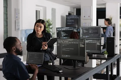 Team of system engineers working on software development with source code 写真素材