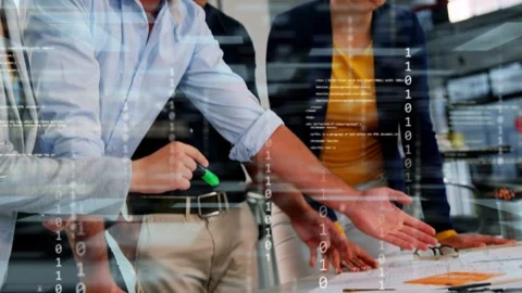 Team at table following man pointing with green highlighter reviewing design Stock Footage 333368400