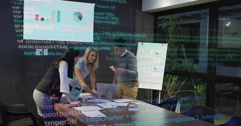Team at table, manager tapping laptop, causing green code overlay marking charts 스톡 사진