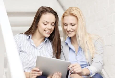 Team with tablet pc computer sitting on staircase 스톡 사진