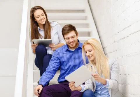 Team with tablet pc computer sitting on staircase 스톡 사진