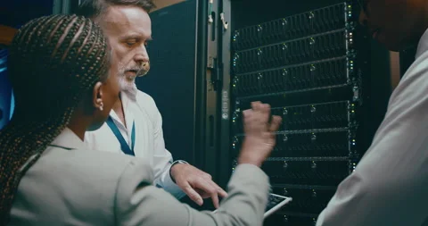 Team, tablet programming and server room for planning, digital screen coding or Stock Footage 262186575