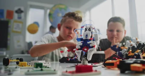 Team of Talented Boys Studying Robotic Arm Model, Learning Engineering and Stock Footage 314775447